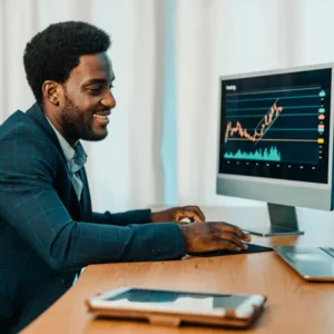 Homem negro olhando gráfico subindo no computador